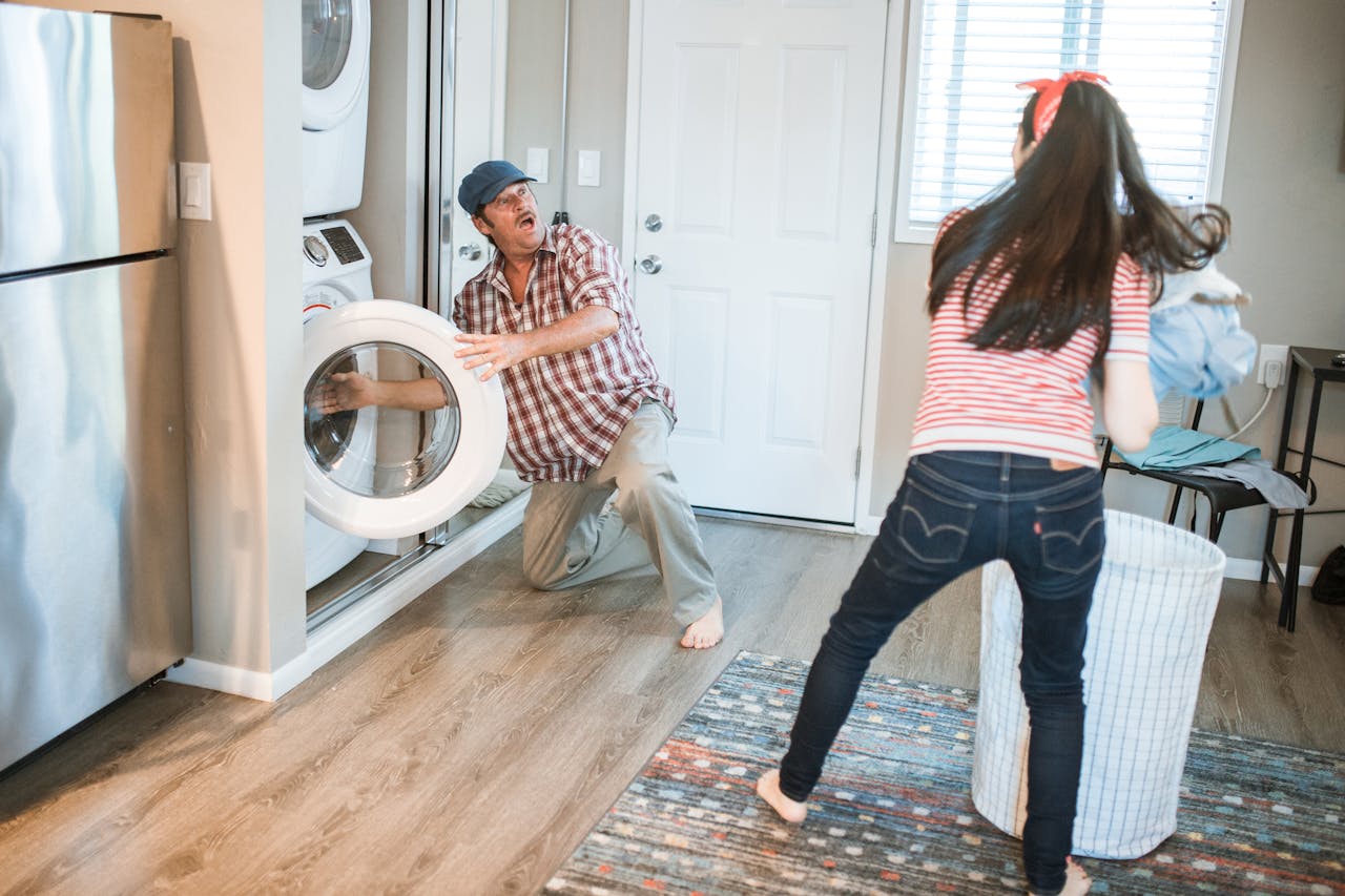 A man and woman doing laundry together in a modern home setting.